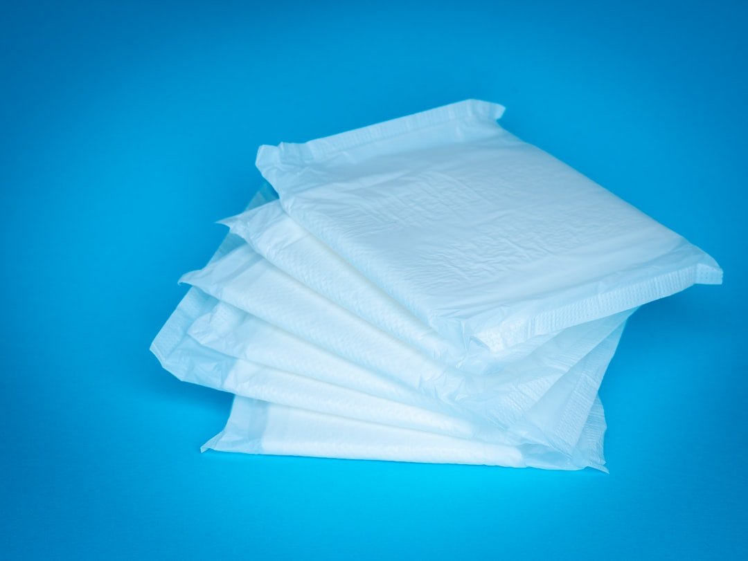 A stack of disposable bed pads on a clean surface, showcasing their texture and size.