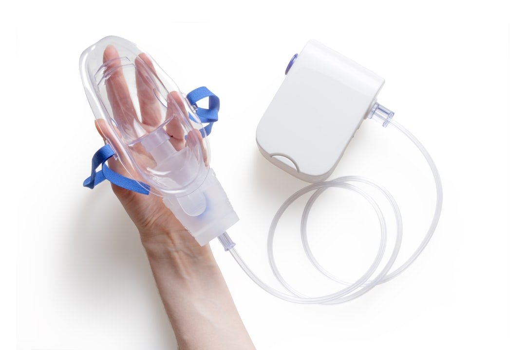 A collection of oxygen masks, tubing, and cannulas on a clean, white background, showcasing the different types used for breathing support.