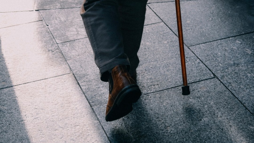 A close-up of a person adjusting the height of a walking cane for better balance and comfort.