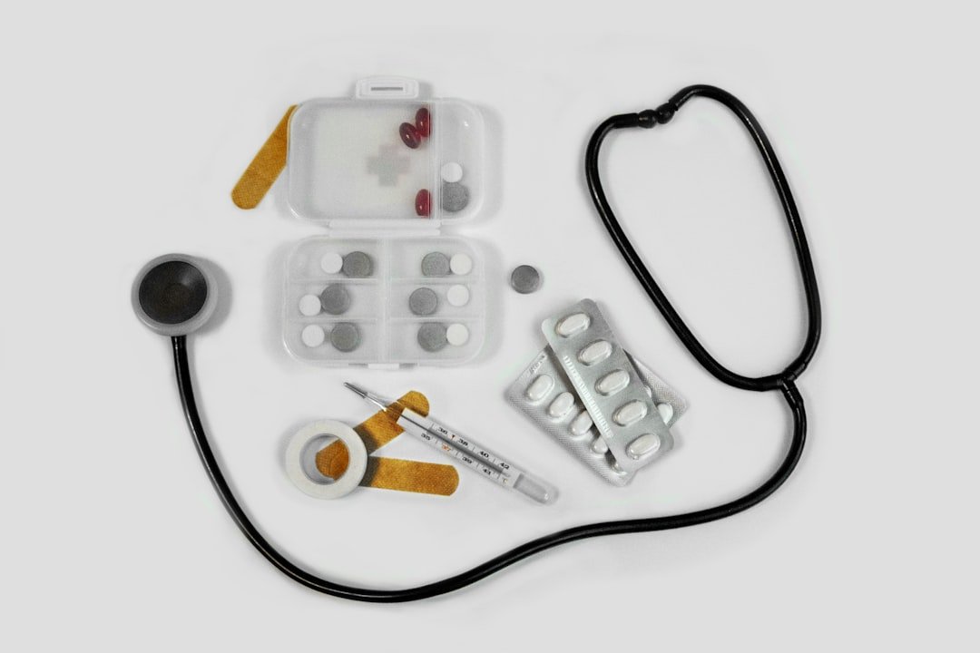 A person cleaning medical equipment at home, showcasing a variety of devices like a nebulizer, blood pressure monitor, and other home health tools.