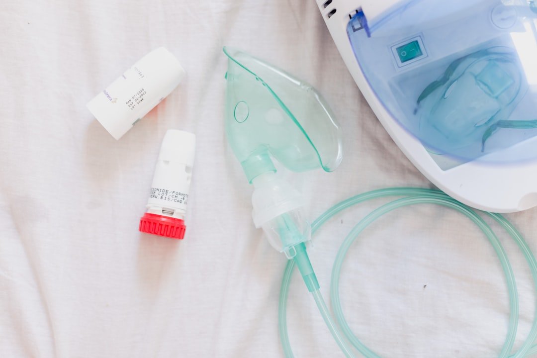A person using a nebulizer with a mask, demonstrating the inhalation of medication in a comfortable setting.