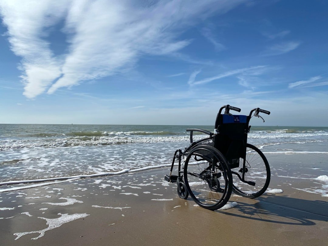 A caregiver assisting a person in a wheelchair, demonstrating safe transfer techniques in a home environment.